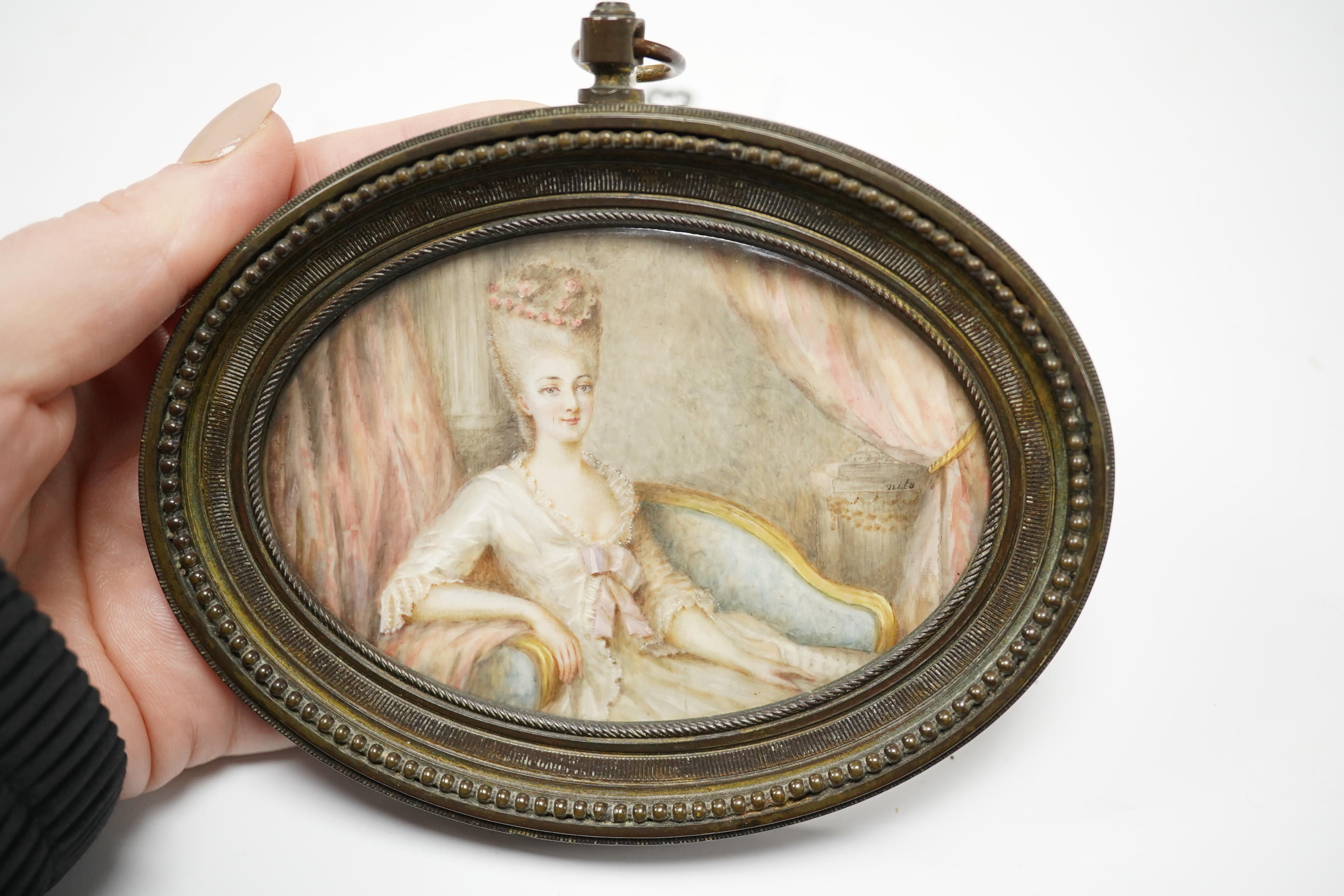 19th century, oval portrait miniature on ivory, signed nito, housed in a cast brass frame, overall 12 x 12.5cm. CITES Submission reference CR58C3KG. Condition - fair